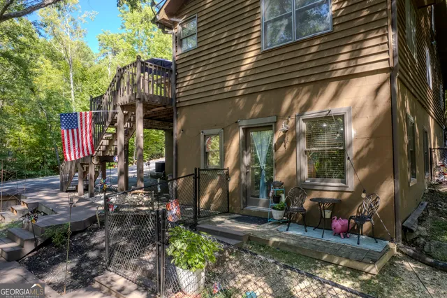 a front view of house along with deck and outdoor seating