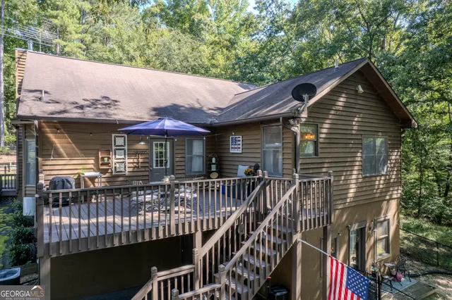 a front view of house with yard and trees around