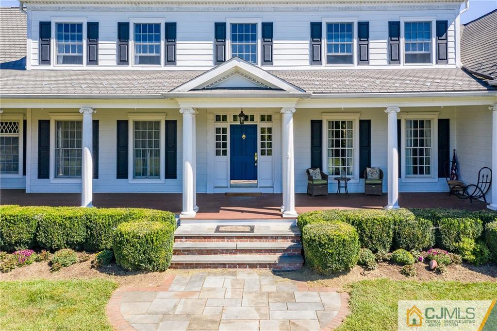 40 Pickle Road Califon, NJ 07830 - Photo 2 of 50 a front view of a house with a lots of potted plants and a bench