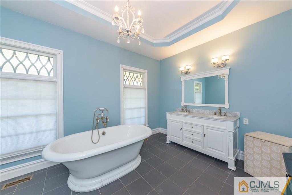 40 Pickle Road Califon, NJ 07830 - Photo 28 of 50 a bathroom with a double vanity sink a mirror and a bathtub