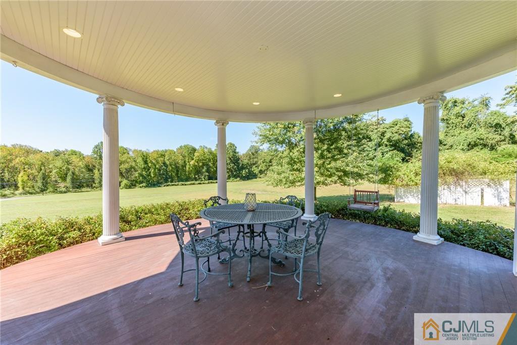 40 Pickle Road Califon, NJ 07830 - Photo 40 of 50 a view of a patio with a table chairs and a backyard