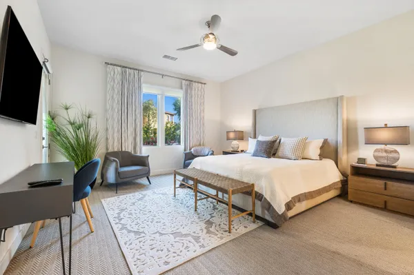 a bedroom with a bed and a potted plant