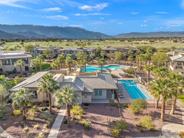 an aerial view of a house with a swimming pool and outdoor seating