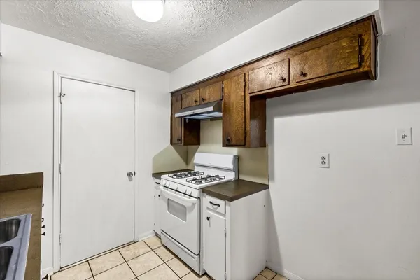 a kitchen with stainless steel appliances a refrigerator and a stove