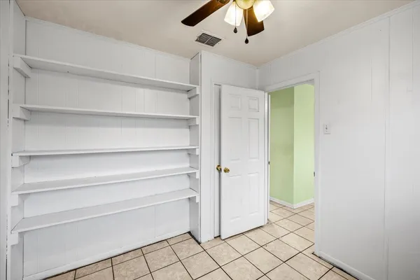 a view of an empty room and closet area
