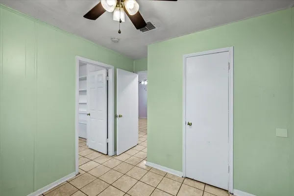 a view of a room with an empty space and a ceiling fan