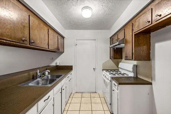 a kitchen that has a sink and a stove