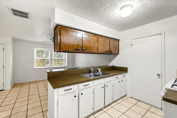 a kitchen with a sink and cabinets