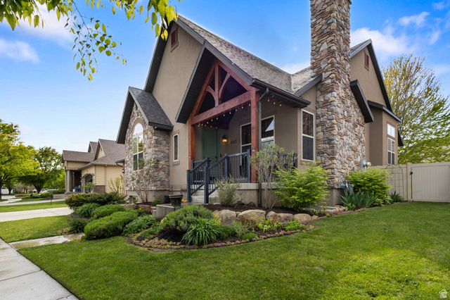 882 Sego Lily Way Mapleton, UT 84664 - Photo 3 of 41 Stucco and stone exterior with a prominent stone chimney