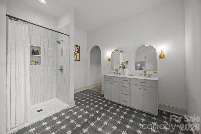 a spacious bathroom with a double vanity sink mirror and shower
