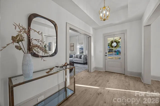 a view of a livingroom with furniture and mirror