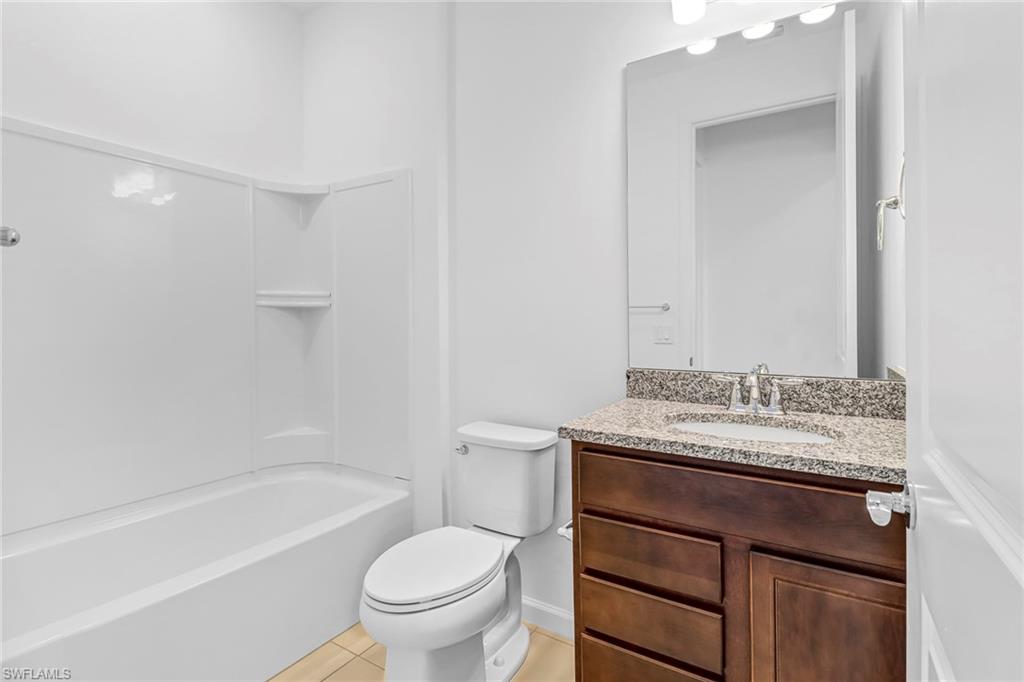 2167 Yellowfin Circle Naples, FL 34114 - Photo 13 of 36 a bathroom with a sink toilet vanity and tub