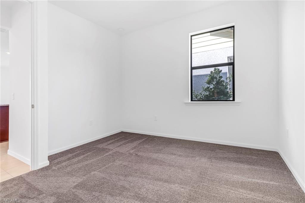 2167 Yellowfin Circle Naples, FL 34114 - Photo 15 of 36 an empty room with windows and closet