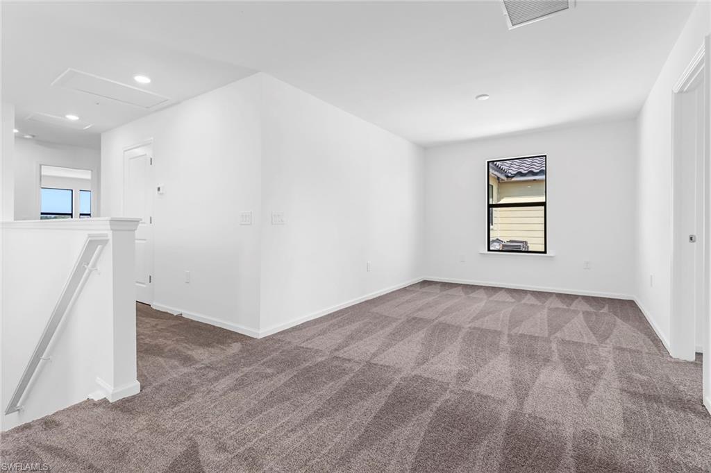 2167 Yellowfin Circle Naples, FL 34114 - Photo 16 of 36 an empty room with windows and refrigerator