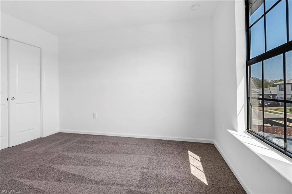 2167 Yellowfin Circle Naples, FL 34114 - Photo 19 of 36 a view of an empty room with a window
