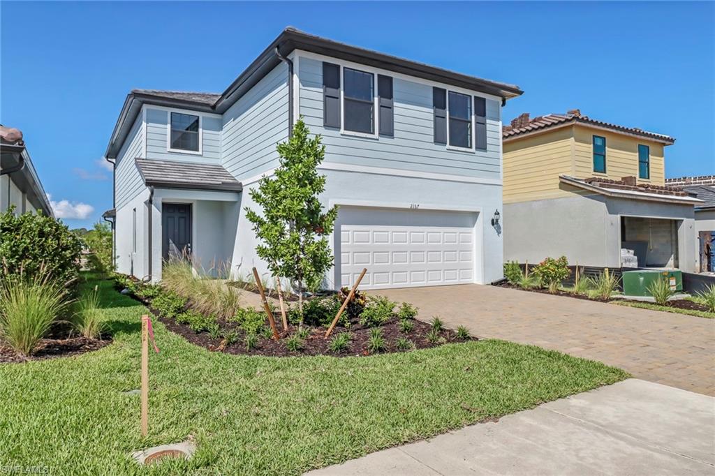 2167 Yellowfin Circle Naples, FL 34114 - Photo 2 of 36 a front view of a house with a yard and porch