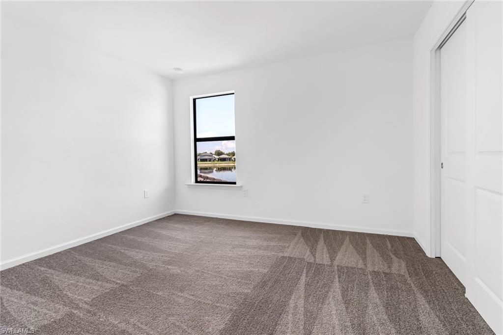 2167 Yellowfin Circle Naples, FL 34114 - Photo 23 of 36 an empty room with windows