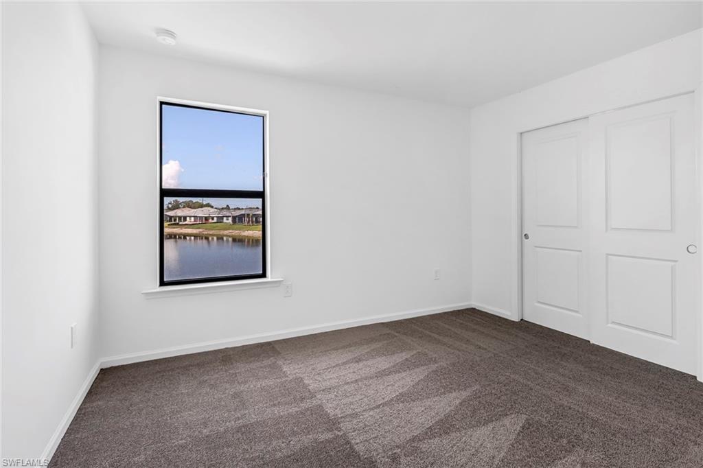 2167 Yellowfin Circle Naples, FL 34114 - Photo 24 of 36 an empty room with a bench