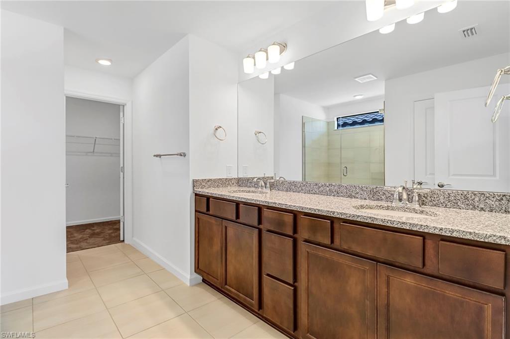 2167 Yellowfin Circle Naples, FL 34114 - Photo 27 of 36 a bathroom with a sink and a mirror