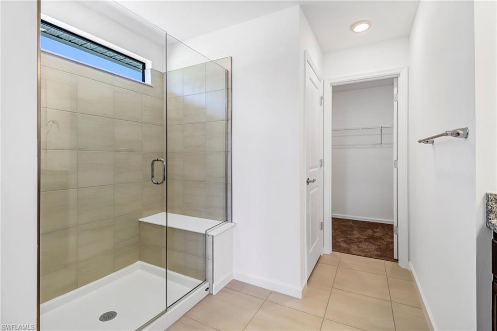 2167 Yellowfin Circle Naples, FL 34114 - Photo 28 of 36 a bathroom with a shower and a glass door