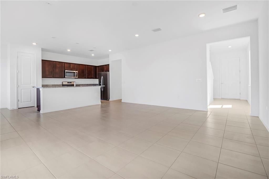 2167 Yellowfin Circle Naples, FL 34114 - Photo 3 of 36 a view of kitchen and refrigerator
