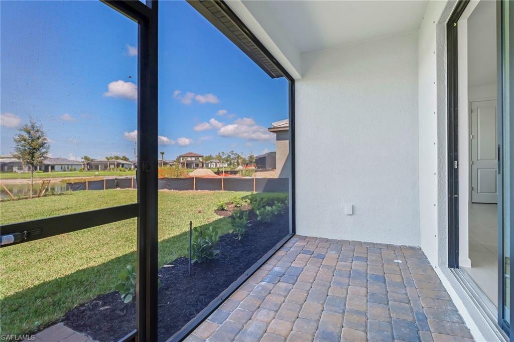 2167 Yellowfin Circle Naples, FL 34114 - Photo 31 of 36 a view of a balcony with floor to ceiling window wooden floor