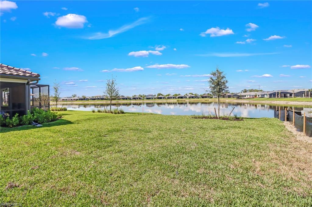 2167 Yellowfin Circle Naples, FL 34114 - Photo 34 of 36 a view of a lake with a city