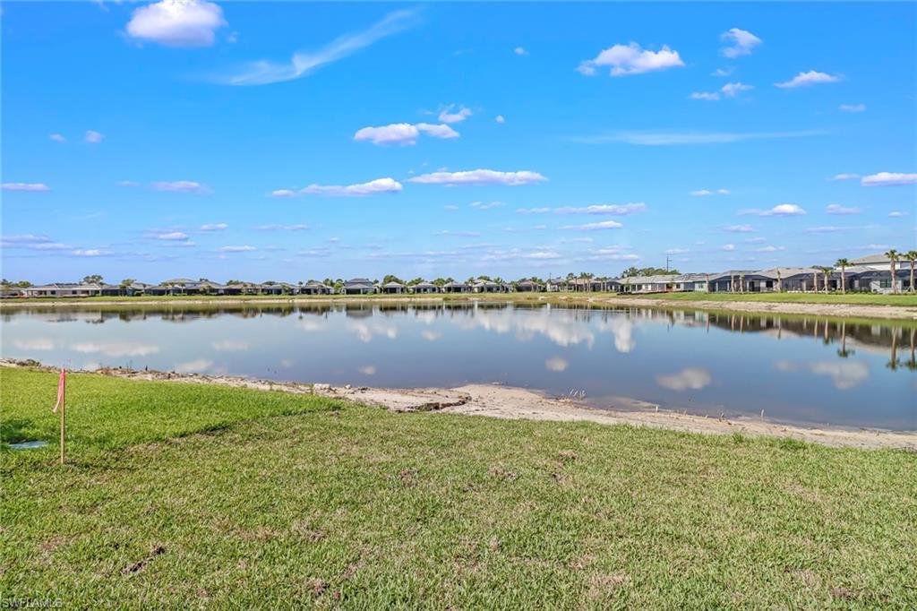 2167 Yellowfin Circle Naples, FL 34114 - Photo 35 of 36 a view of a lake with houses in the back