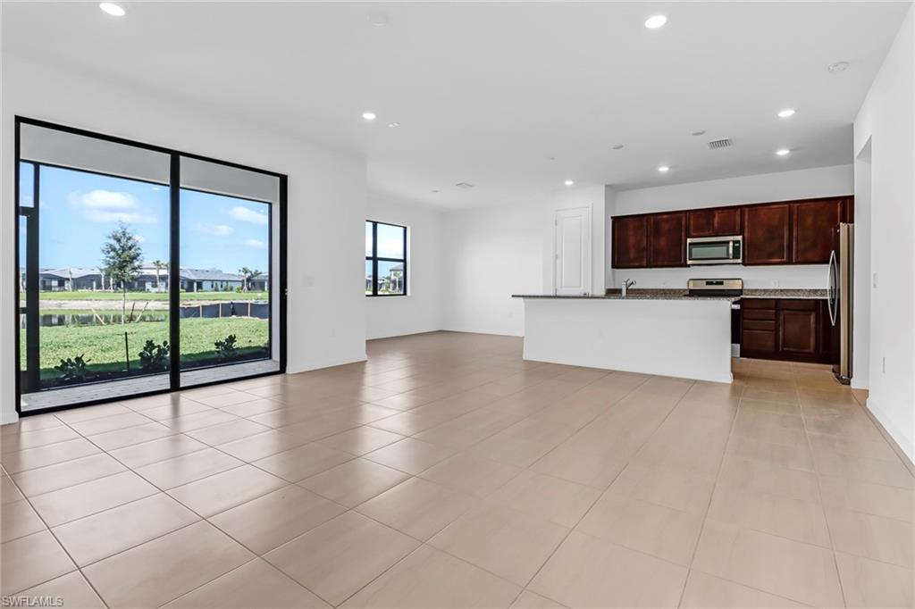 2167 Yellowfin Circle Naples, FL 34114 - Photo 4 of 36 a view of kitchen with stainless steel appliances granite countertop a stove top oven a sink a counter space and cabinets
