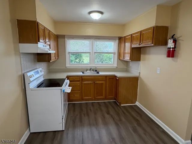 a kitchen with a sink a stove and cabinets