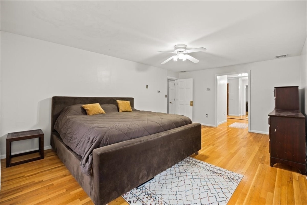 211 Cherry Street Bridgewater, MA 02324 - Photo 16 of 39 a bedroom with a bed and wooden floor