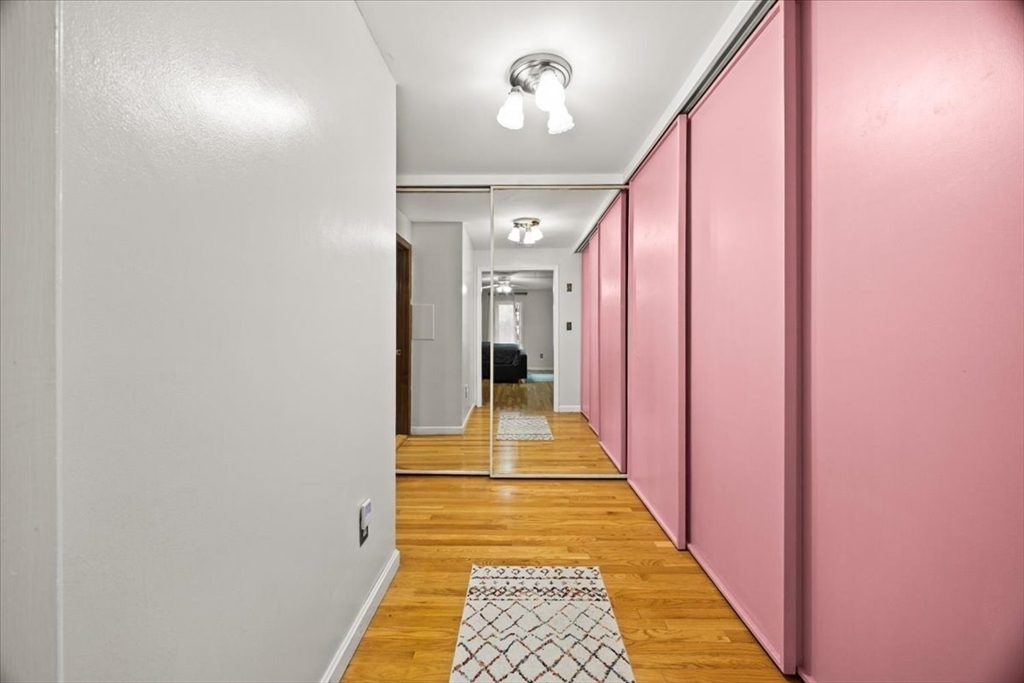211 Cherry Street Bridgewater, MA 02324 - Photo 17 of 39 a hallway with a dining table and a chandelier