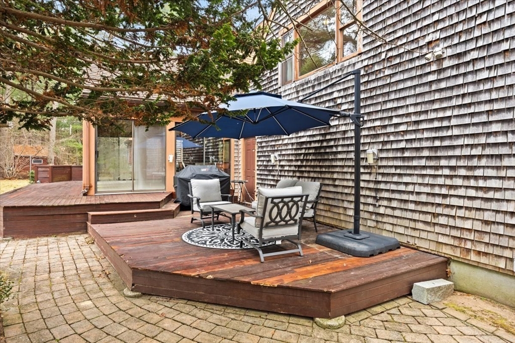 211 Cherry Street Bridgewater, MA 02324 - Photo 29 of 39 a view of a patio with a table and chairs under an umbrella
