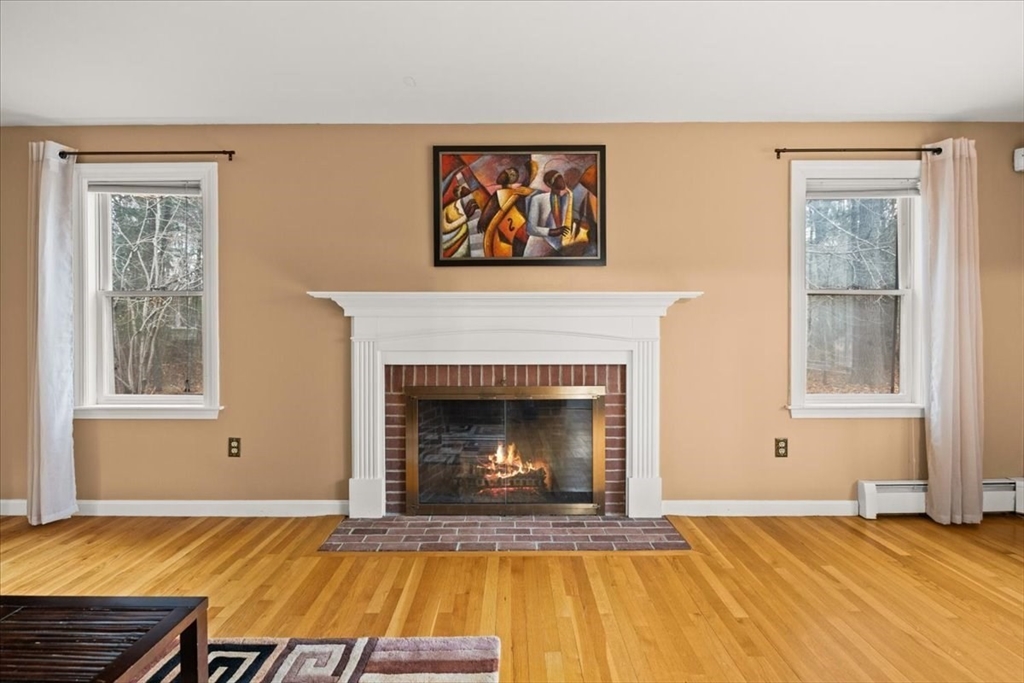 211 Cherry Street Bridgewater, MA 02324 - Photo 9 of 39 a living room with a fireplace and a window