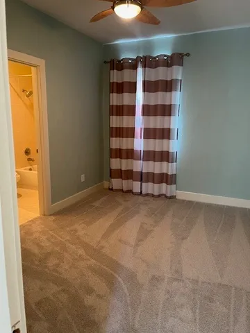 a view of an empty room with a fireplace and cabinet