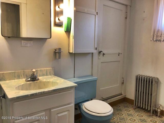72 Thomas Road Moscow, PA 18444 - Photo 13 of 14 a bathroom with a sink a toilet and a light fixture