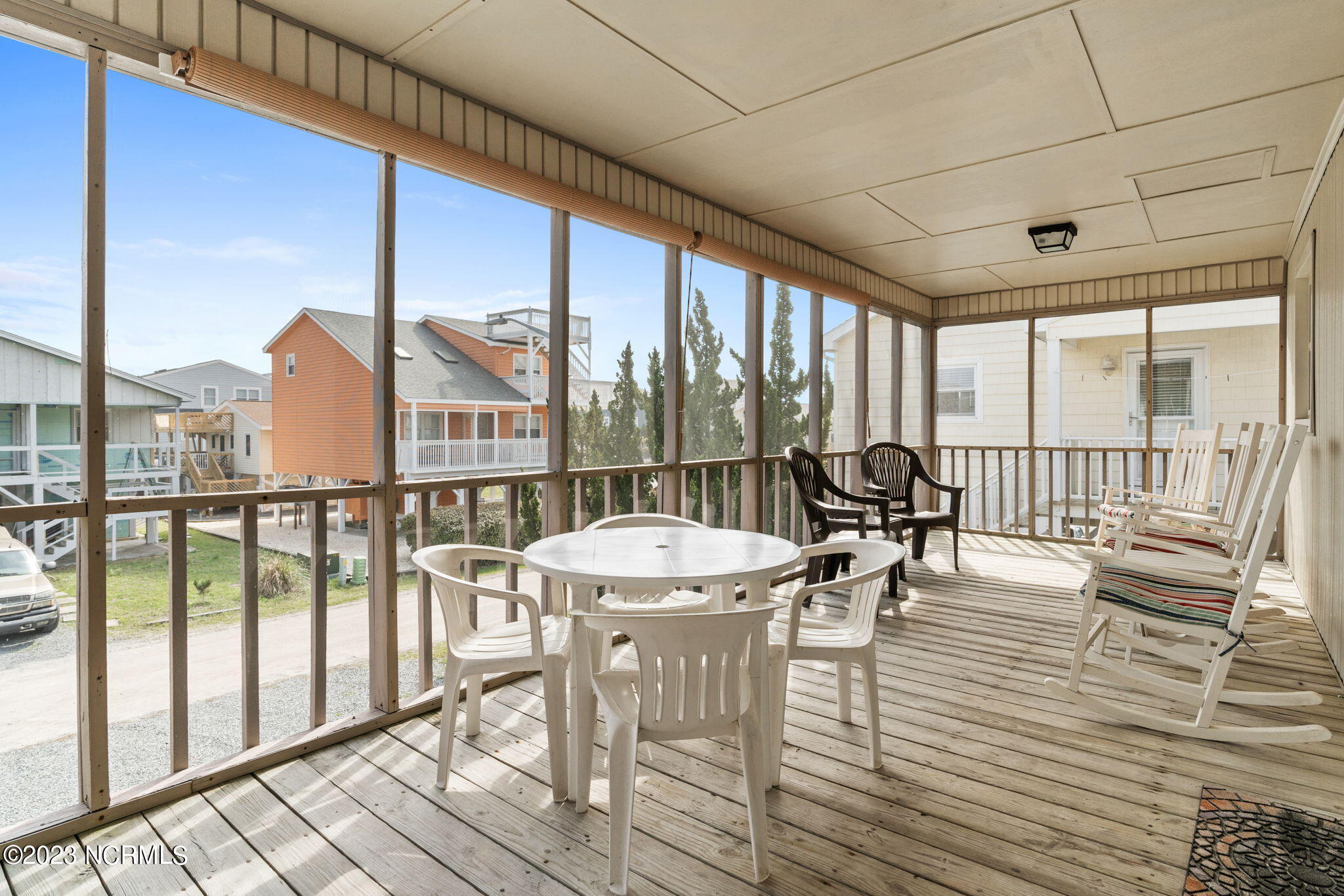 438 3rd Street Sunset Beach, NC 28468 - Photo 12 of 77 Expansive front screened porch.
