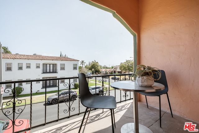 a view of a chairs and table in the balcony