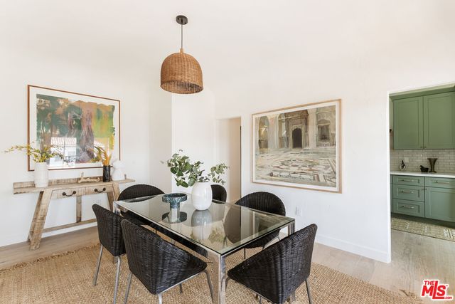 a kitchen with a sink a refrigerator and cabinets