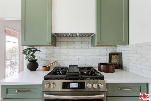a kitchen with stainless steel appliances a sink stove and cabinets