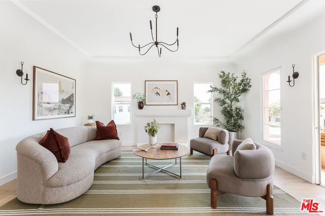 a living room with furniture and a large mirror