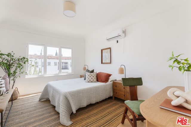 a bedroom with a bed and a table in it