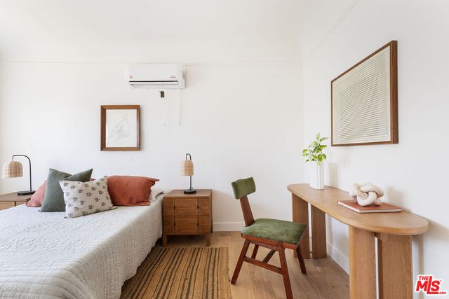 a bedroom with a bed and a painting on the wall