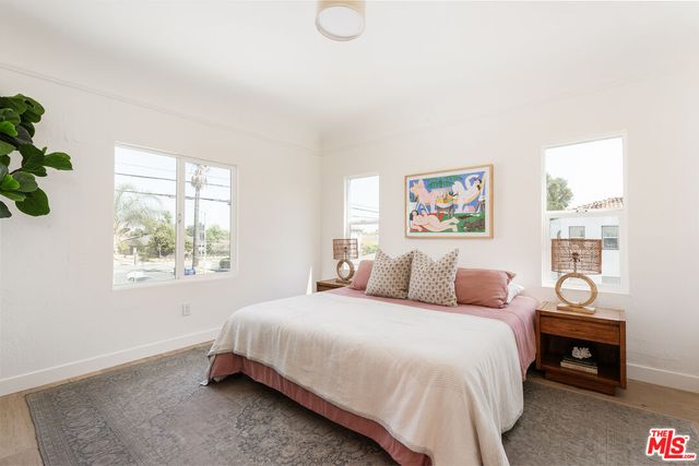 a bedroom with a bed and a potted plant