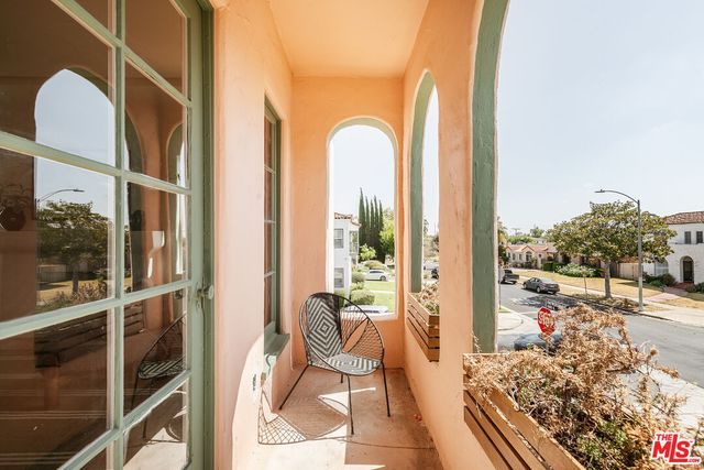 a view of a balcony with chair and table