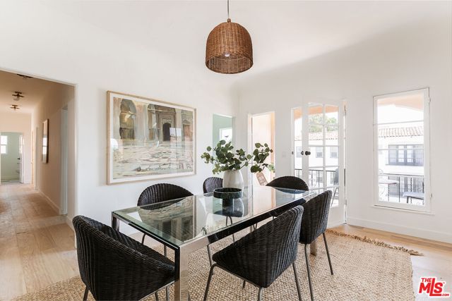 a dining room with furniture and wooden floor