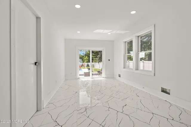 a kitchen with white cabinets and appliances