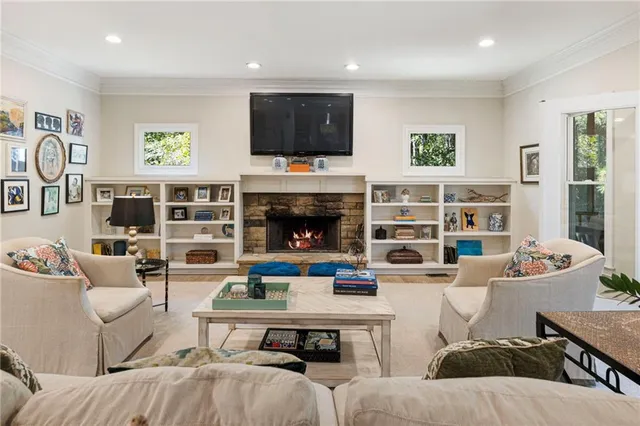 a living room with furniture a flat screen tv and a fireplace