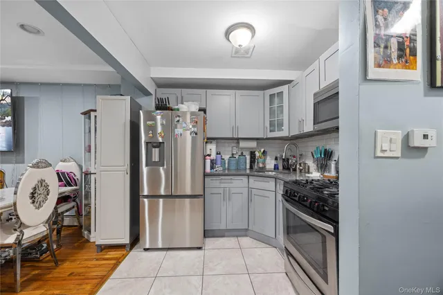 a kitchen with stainless steel appliances granite countertop a refrigerator and a stove top oven