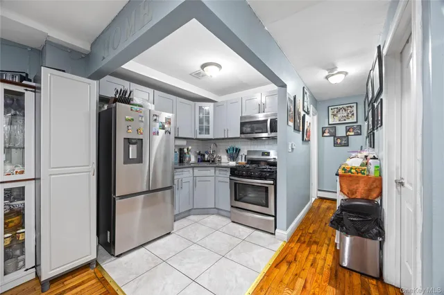 a kitchen with stainless steel appliances granite countertop a refrigerator stove and sink